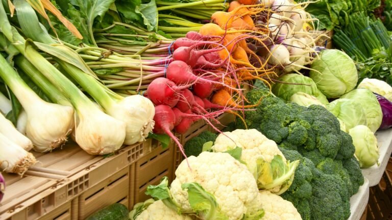 Étal de marché avec chou-fleur, brocolis, radis et oignons de saison